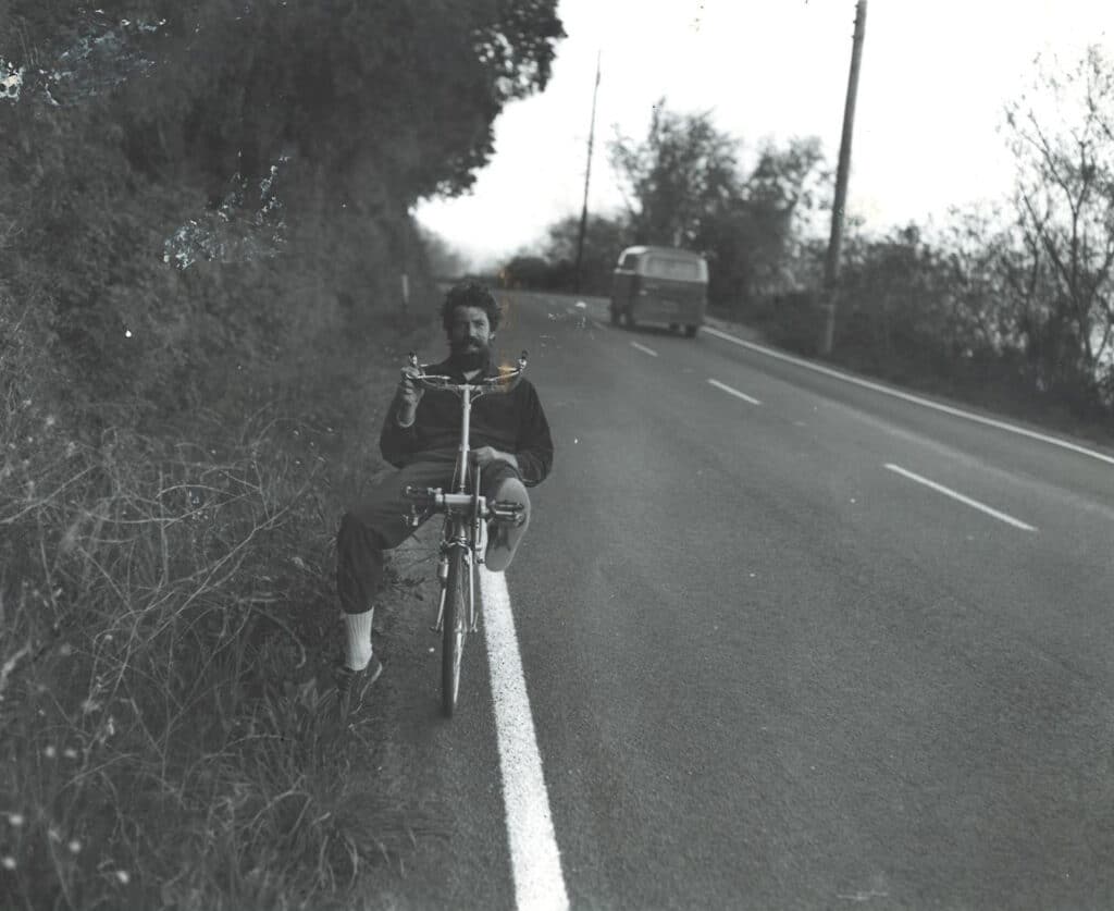 Doug White on recumbent on the site of a road.